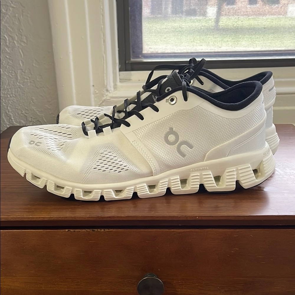 On Running White and Black Athletic Shoes with Cloud Cushioning